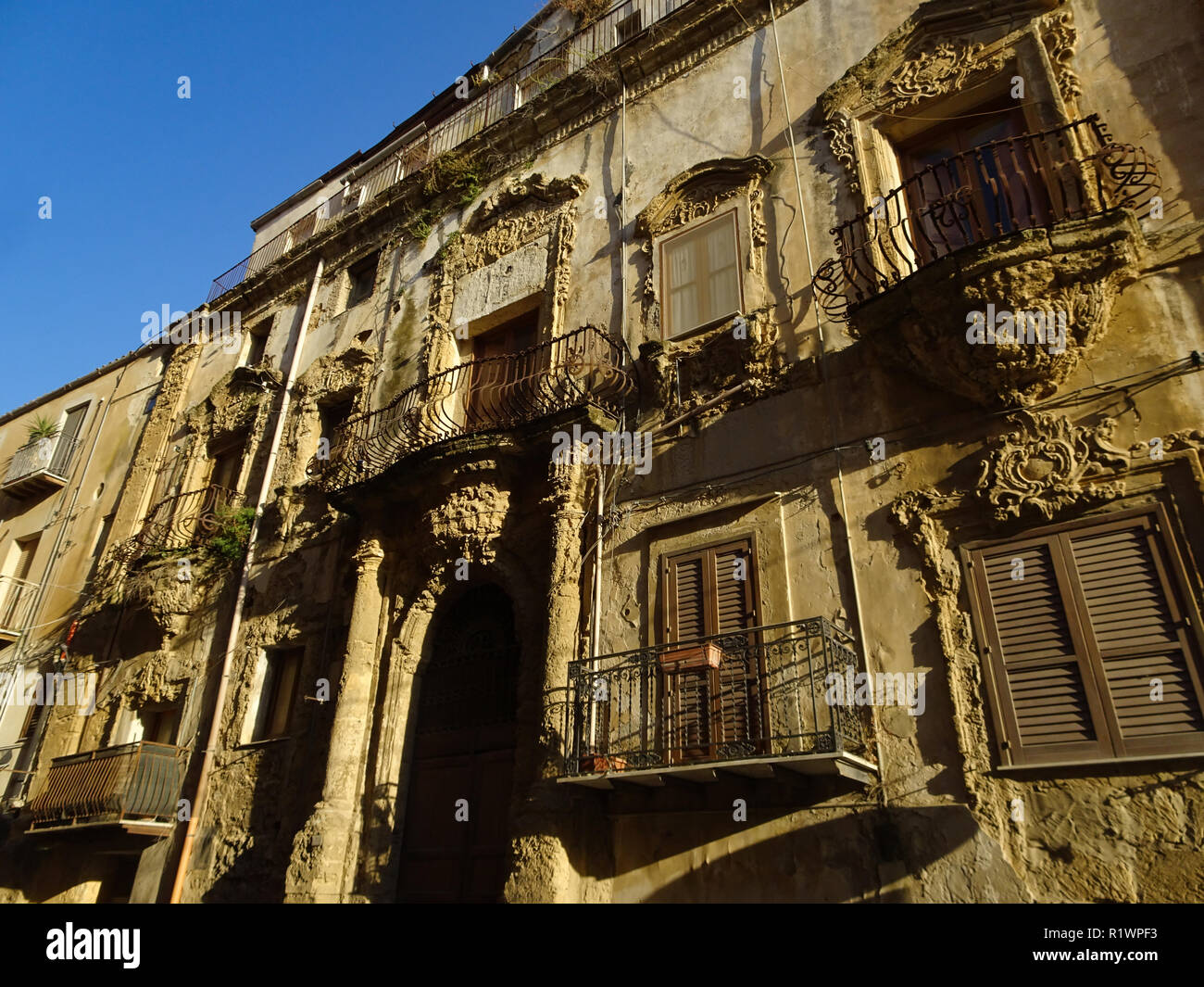Una vecchia facciata di una casa in Sicilia nel tardo pomeriggio per il golden ora Foto Stock