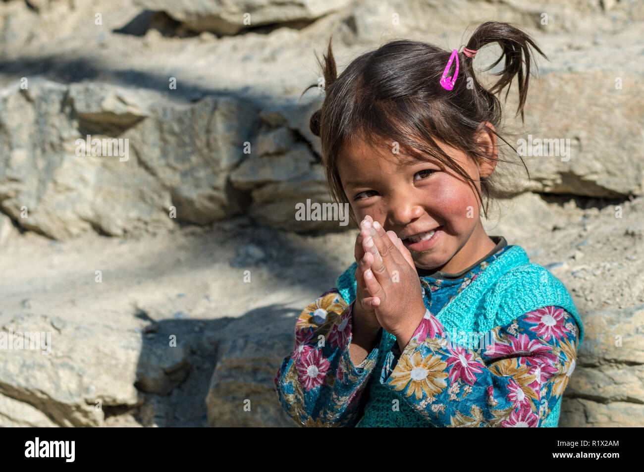 Un ritratto di una piccola ragazza locale, pregando Foto Stock
