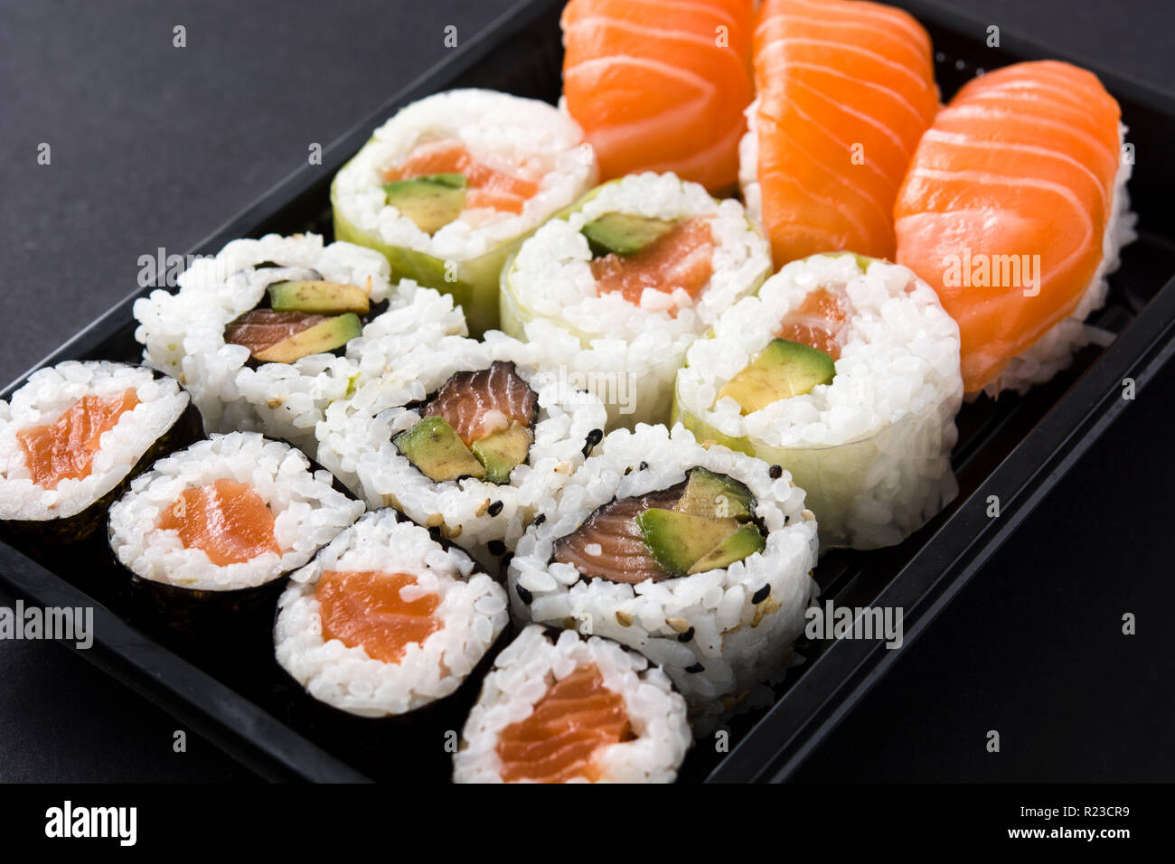Sushi pack con il nigiri e maki su sfondo nero Foto Stock