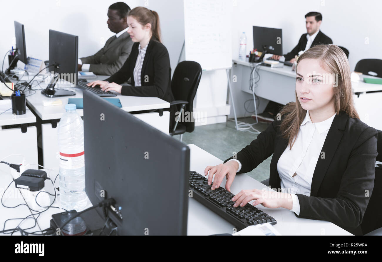 La gente di affari di diverse gare con i laptop avente una proficua giornata di lavoro in coworking Foto Stock