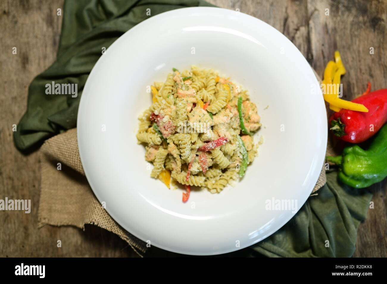 Salmone fusilli con concetto vegetale su un tavolo di legno Foto Stock