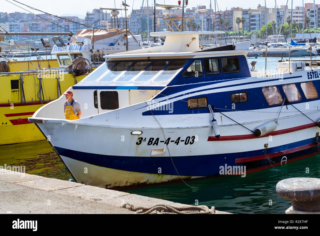 Blanes, Spagna - 31 maggio 2018: Pesca barche e yacht ormeggiati al molo nel porto Blanes. Pescatori scaricano delle catture di pesce di mare, ostriche, calamari, delicatezze di mare. Asta del pesce per i grossisti e i ristoranti Foto Stock