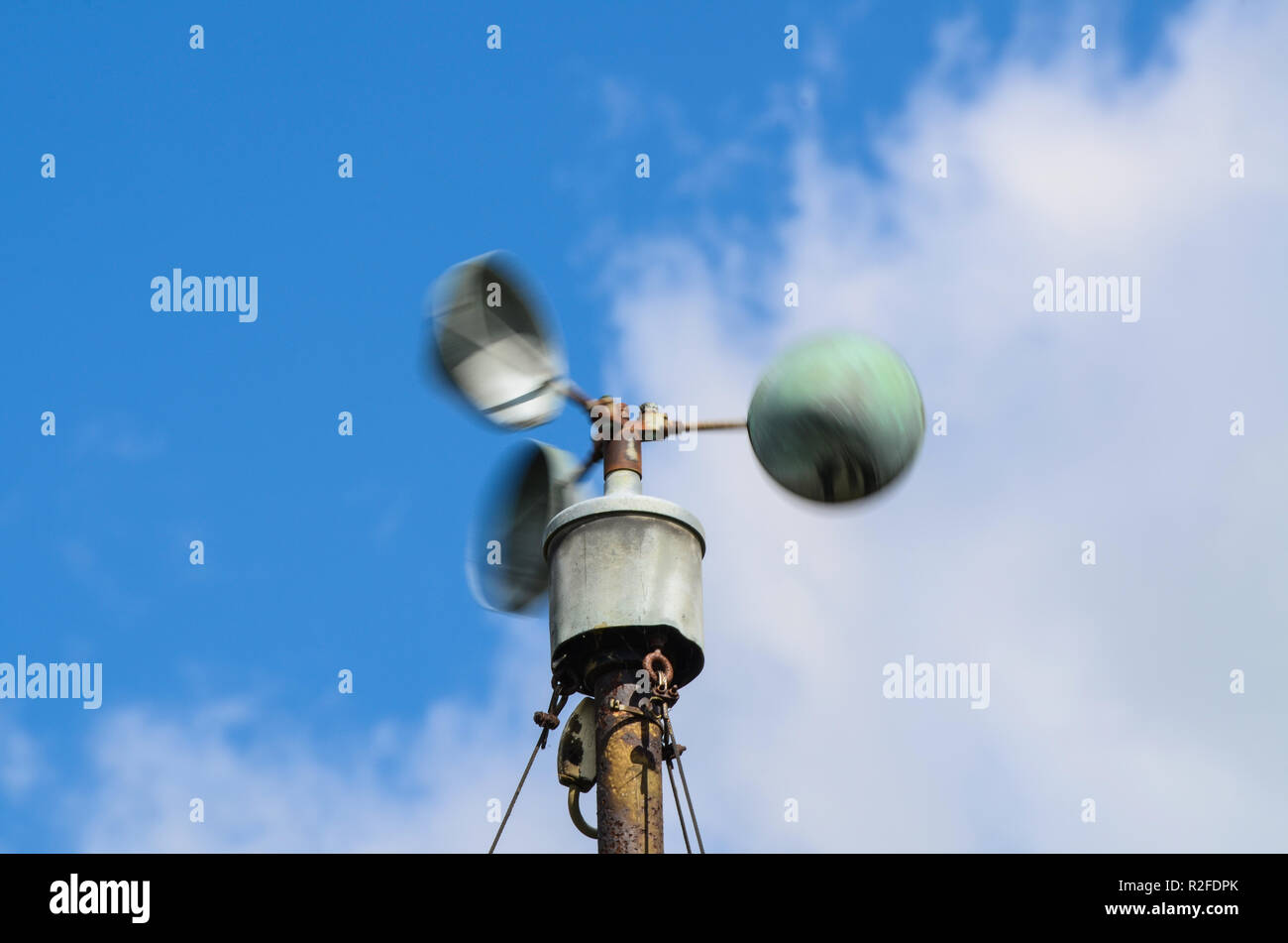 Tazza semisferica anemometro per la velocità del vento manometro girano a velocità in alta venti forti. Stazione meteo strumento sulla North Weald airfield. Nuvole, cielo Foto Stock