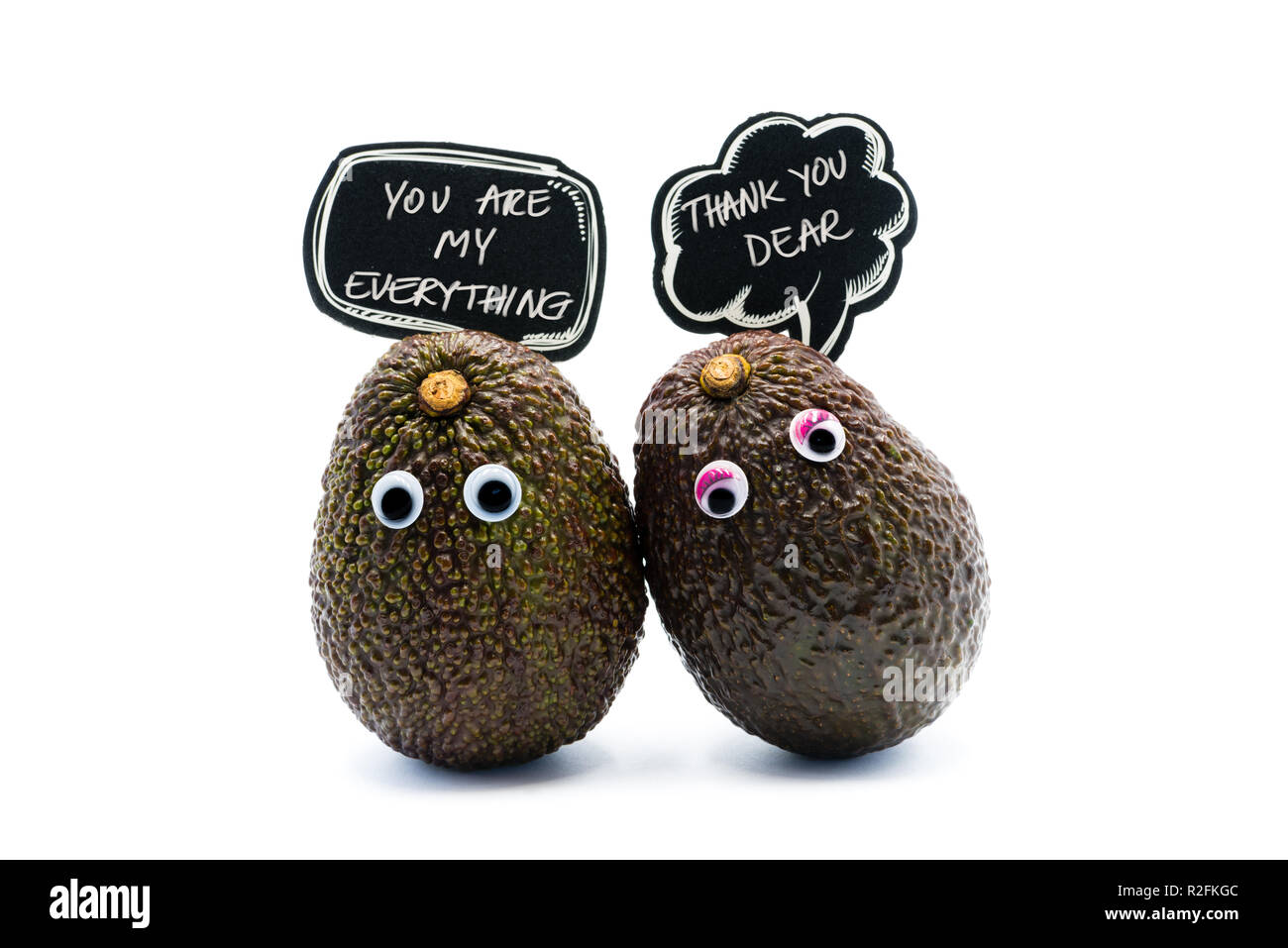 Romantico avocadi giovane con googly occhi e fumetti con testo, divertente e alimentare il concetto di amore per progetti creativi. Foto Stock