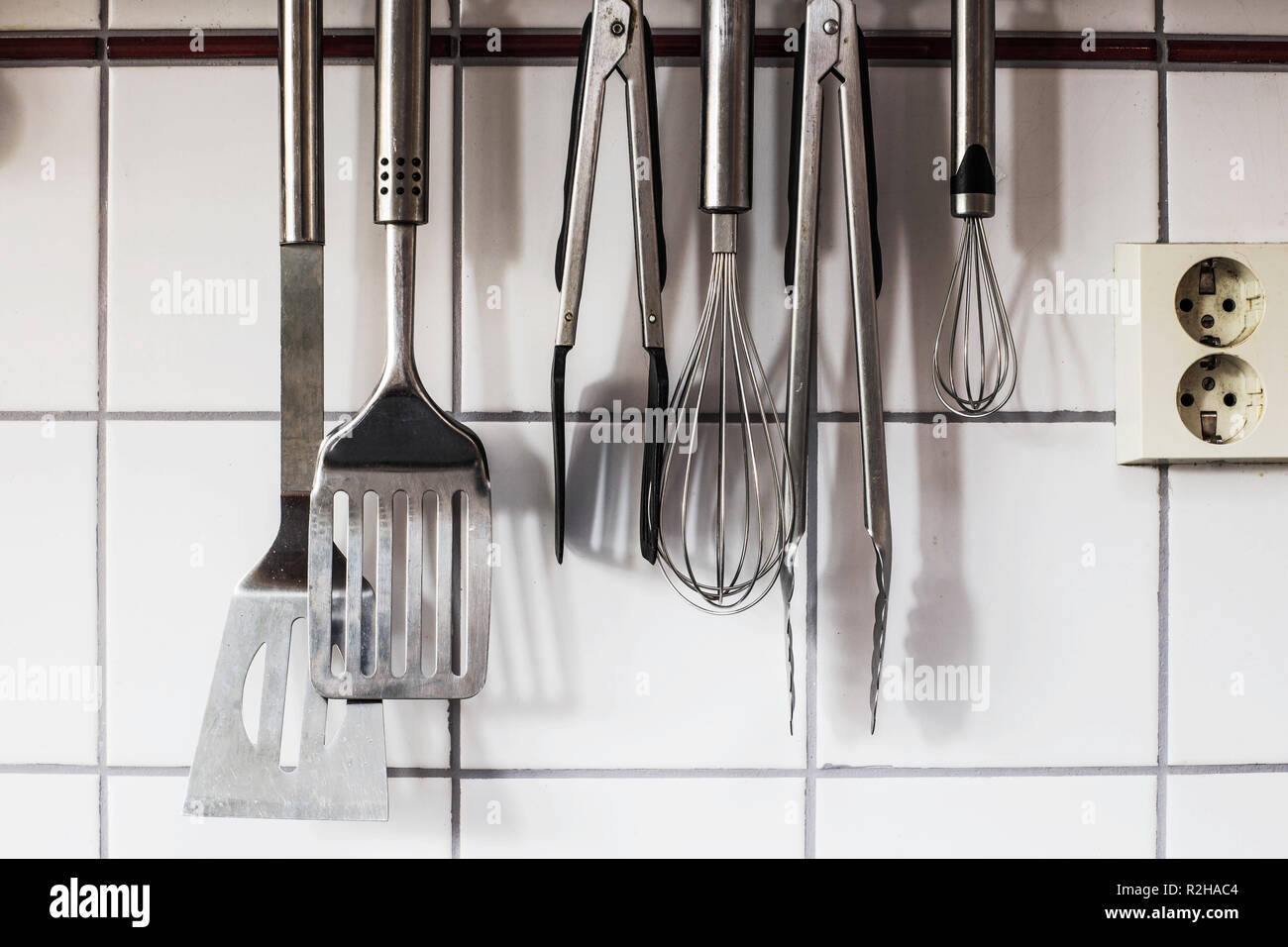 Le stoviglie sono appesi al muro in cucina Foto Stock