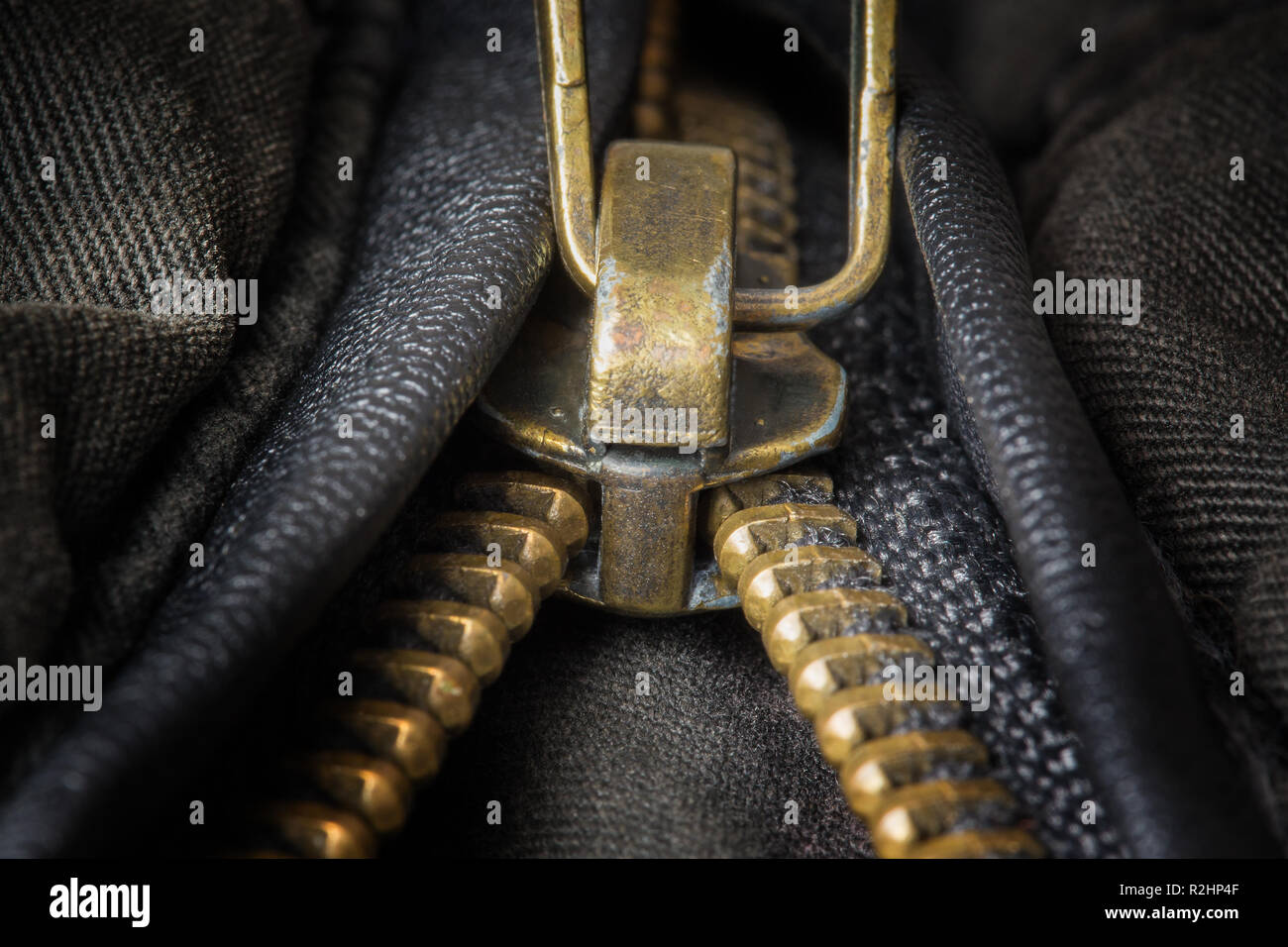 Ottone decompressi zipper closeup sui vestiti scuri Foto Stock