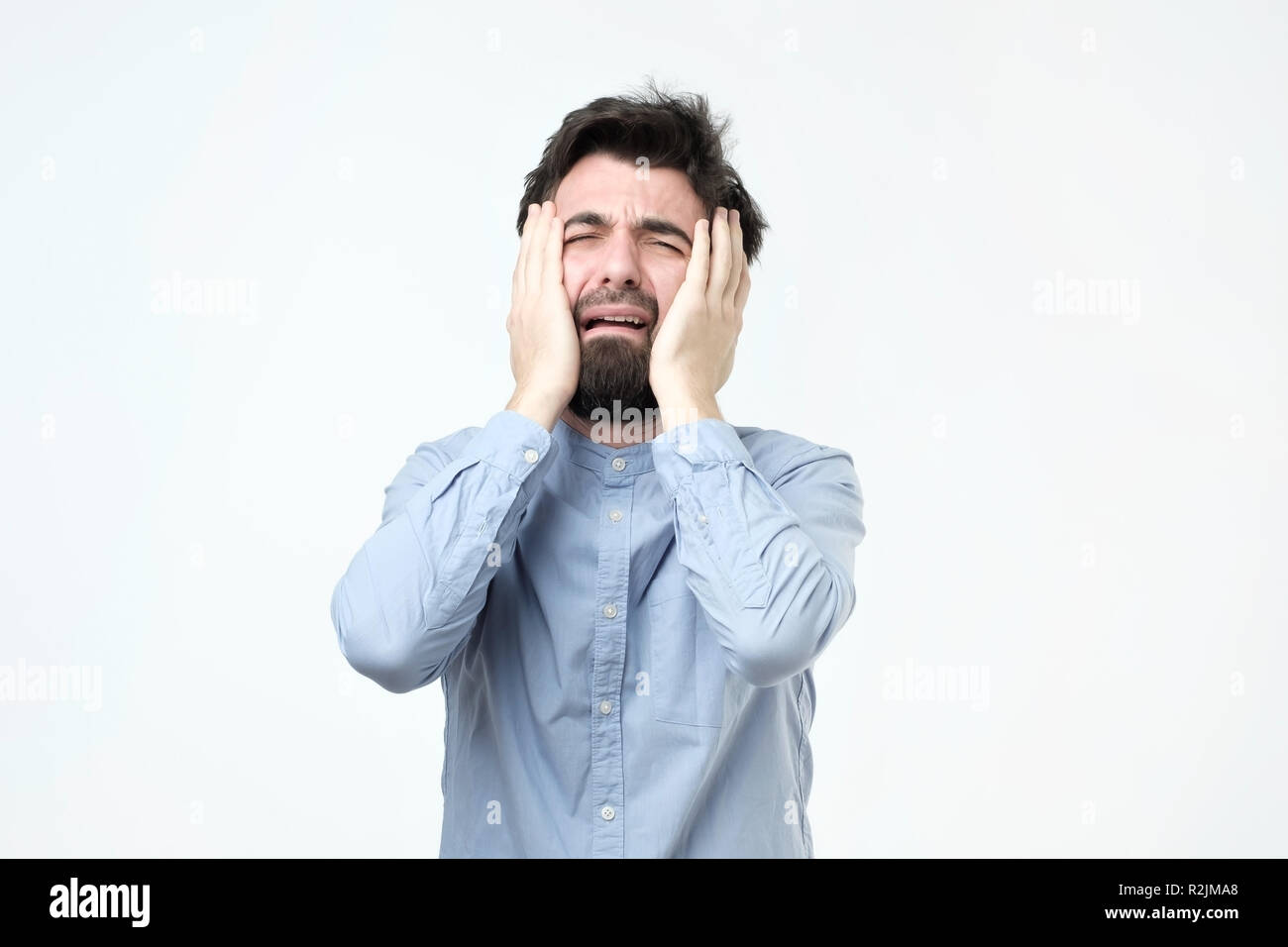 Giovane uomo ispanico con la barba è il pianto. Foto Stock Giovane uomo ispanico con la barba è il pianto. Foto Stock