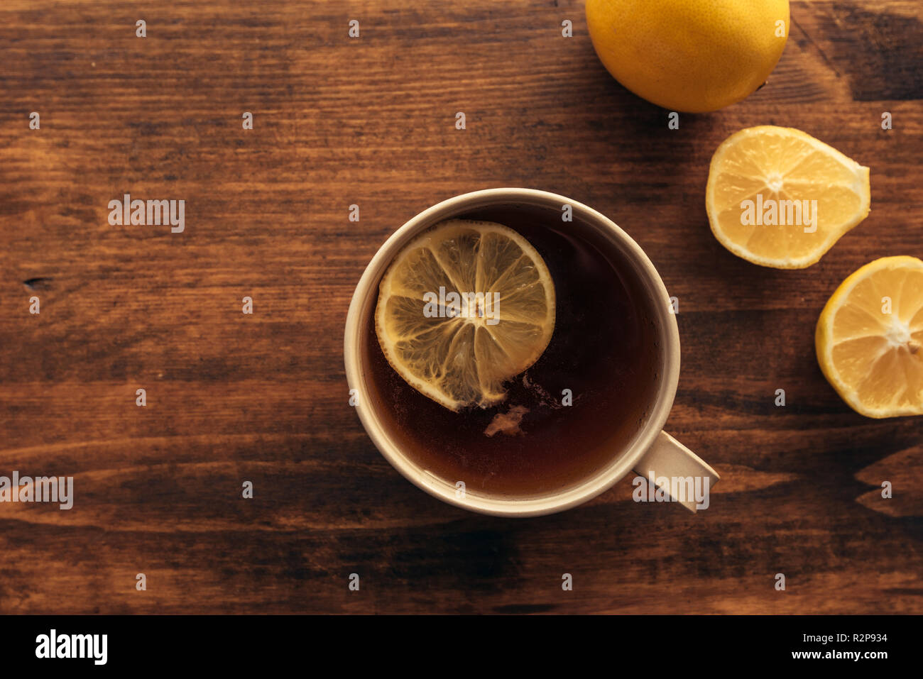 Tazza di tè e di limone fresco, vista dall'alto del tavolo con bevanda calda con nostalgico retrò tone Foto Stock