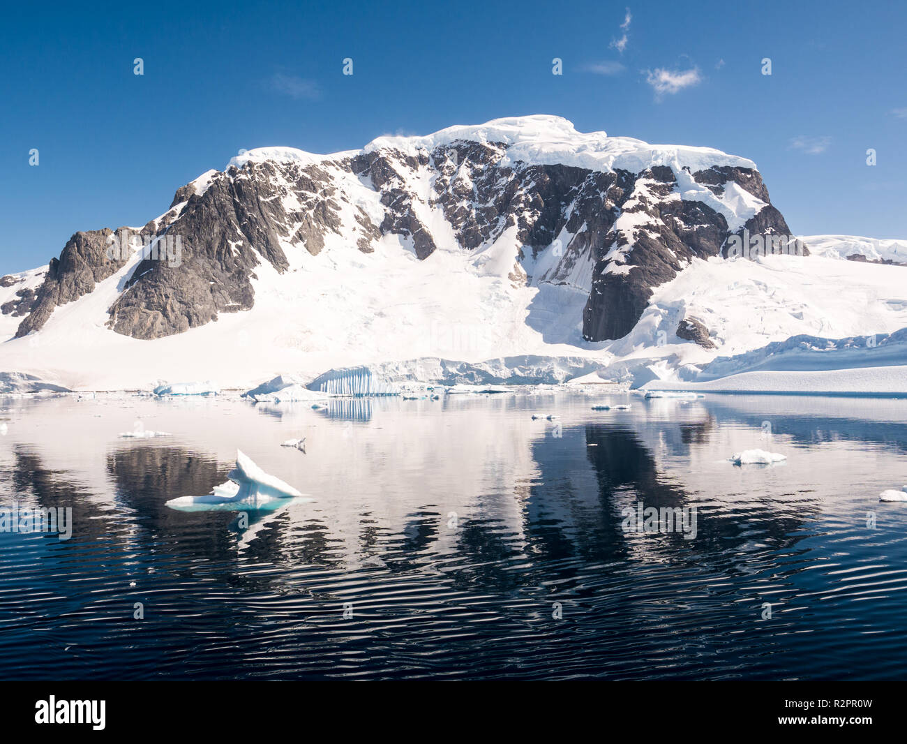 Montagne innevate di Danco isola sulla soleggiata giornata estiva con cielo blu nel canale Errera, Penisola Antartica, Antartide Foto Stock