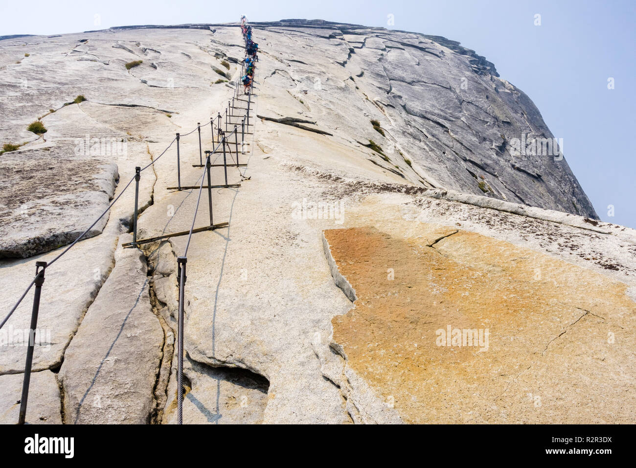 Salendo a mezza cupola i cavi su un giorno d'estate; il fumo visibile nell'aria da Ferguson fuoco; il Parco Nazionale di Yosemite in California Foto Stock