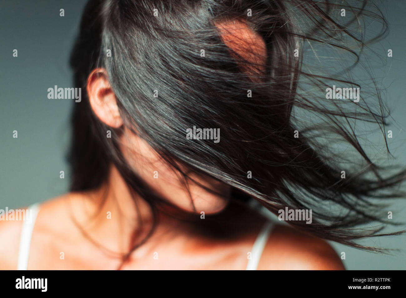 Vento capelli nel volto di donna Foto Stock