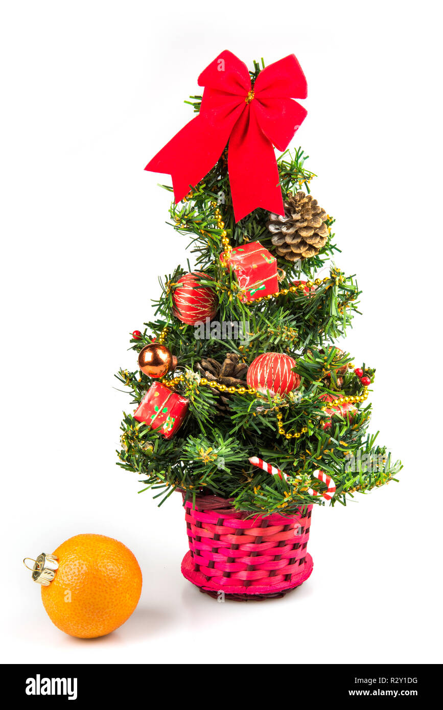 Piccolo albero di Natale e mandarino su sfondo bianco Foto Stock