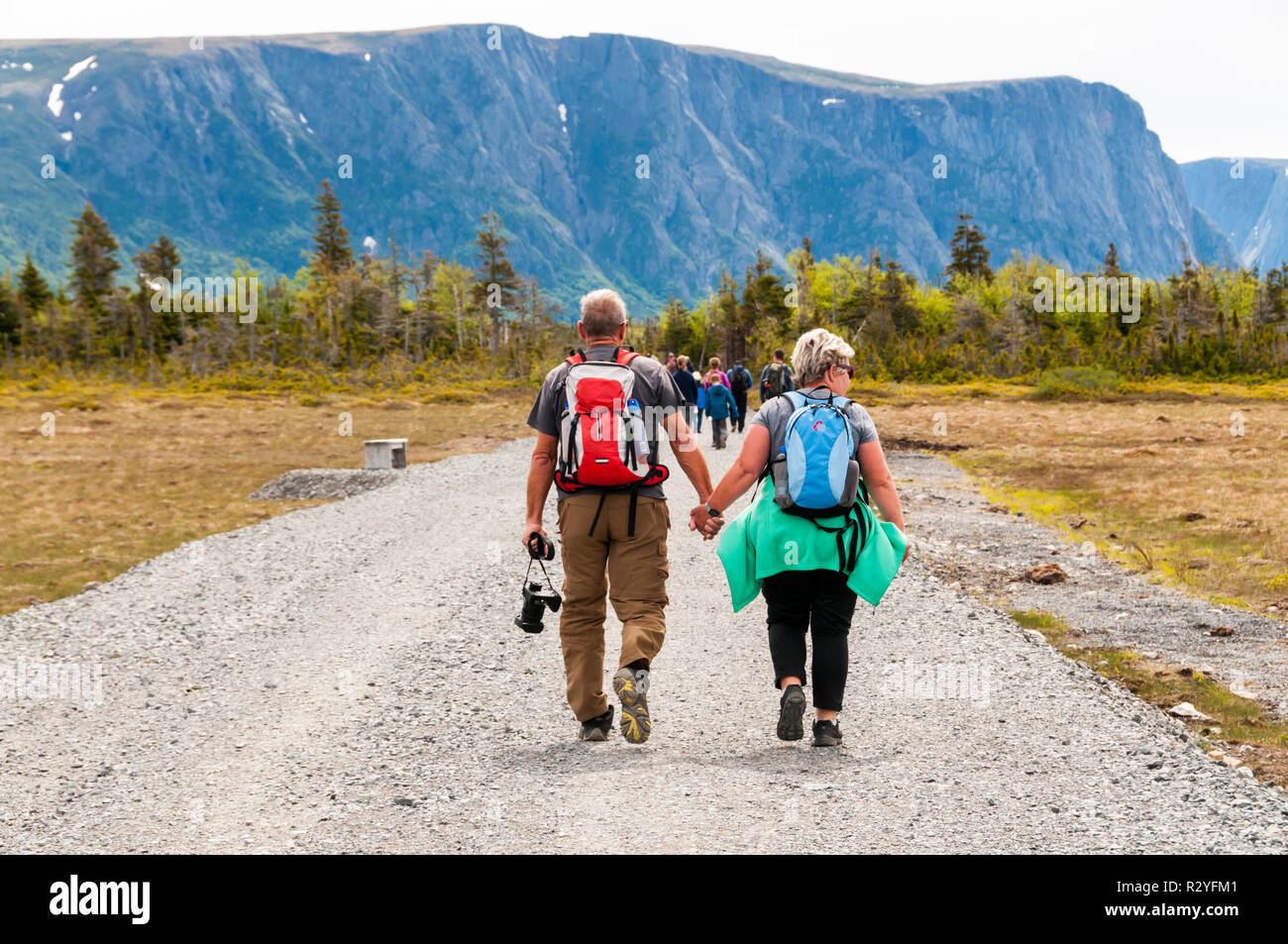 La gente a piedi lungo via all inizio del Western Brook stagno nel Parco Nazionale Gros Morne, Terranova. Intestazione del gruppo di viaggio in barca. Foto Stock