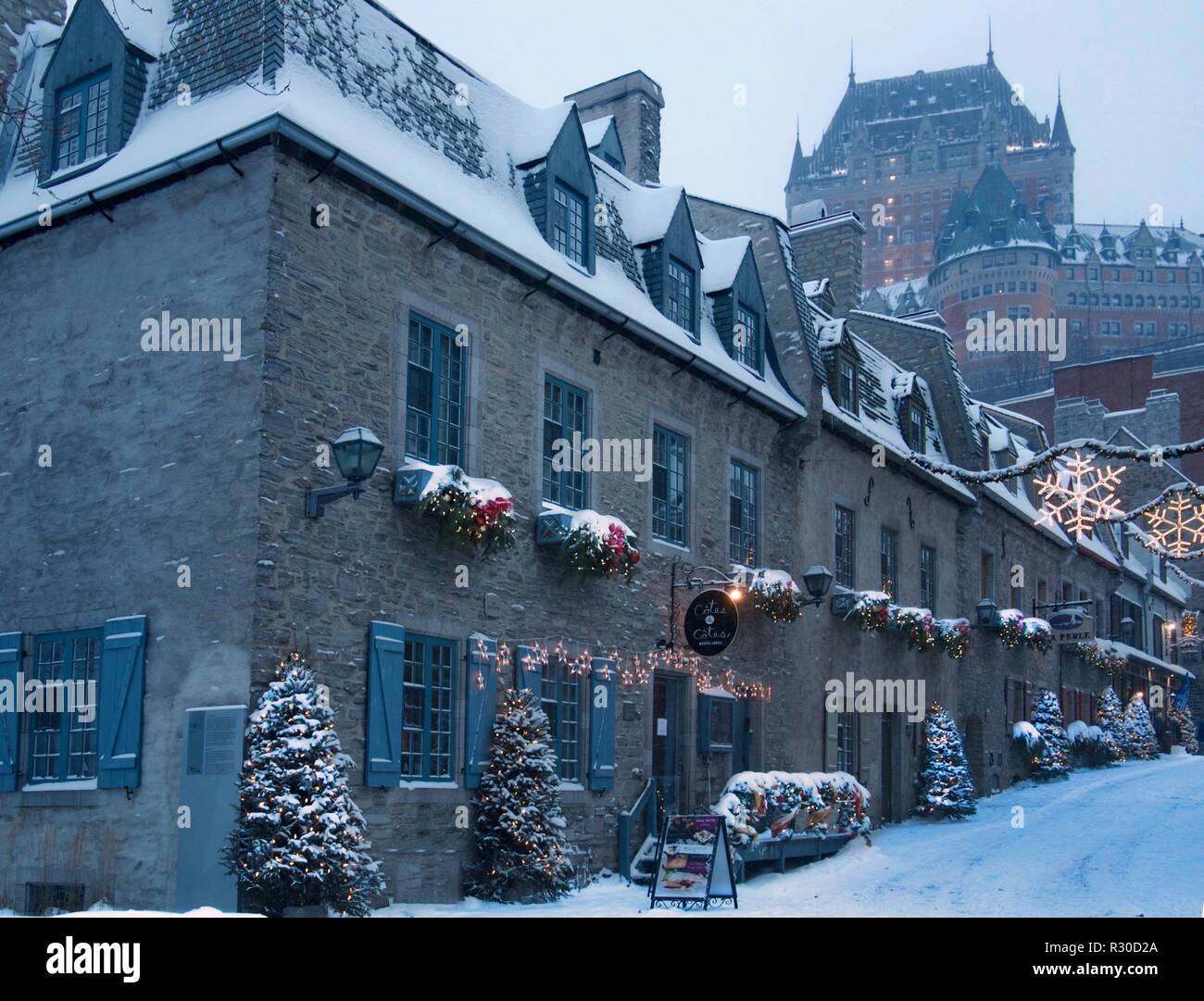 Le strade del quartiere Petit-Champlain durante la stagione di natale dopo una tempesta di neve al tramonto e la vista del Chateau Frontenac Foto Stock