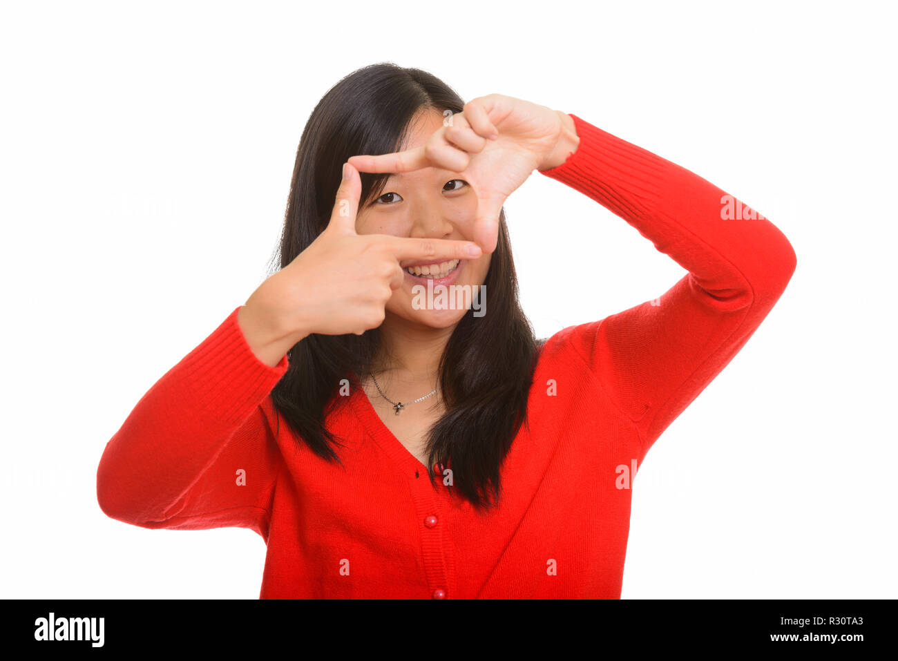 Felice giovane donna asiatica la messa a fuoco con le dita Foto Stock