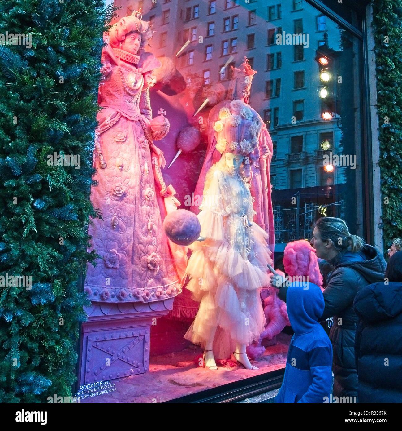 NEW YORK, USA, 20NOV2018. Una donna mostra il suo figlio una finestra di Bergdorf Goodman Luxury department store in Midtown Manhattan. Foto di Enrique Shore Foto Stock