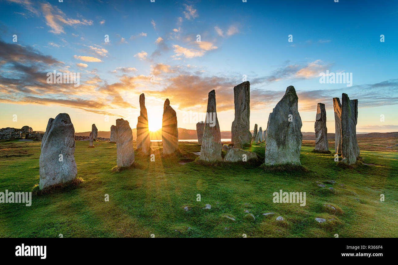 Tramonto sopra il cerchio di pietre di Callanish sull'isola di Lewis in Scozia Foto Stock