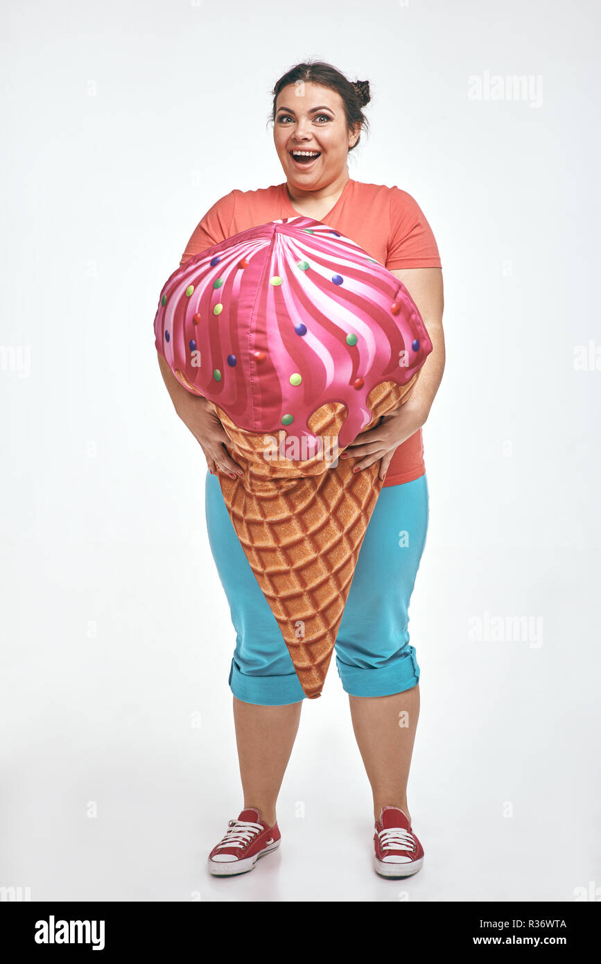 Bruna, chubby donna è in possesso di un enorme gelato Foto Stock