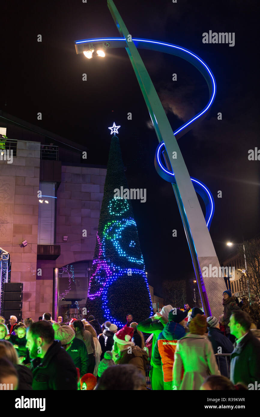 Lisburn, Irlanda del Nord, 22 Novembre, 2018. Una folla di persone tra cui molti giovani famiglie, linea Bow Street e la piazza del mercato in Lisburn centro a guardare una lanterna parade che coinvolgono gli scolari locali accompagnati da esecutori di carnevale per l annuale le luci di Natale Switch-On. Essa segna l'inizio di Lisburn Light Festival, 22 novembre - 25 gennaio, quando oltre un milione di si illumineranno il centro citta'. Il Sindaco, assessore Uel Mackin acceso le luci di Natale abilmente coadiuvato da Santa. Credito: Ian Proctor/Alamy Live News Foto Stock