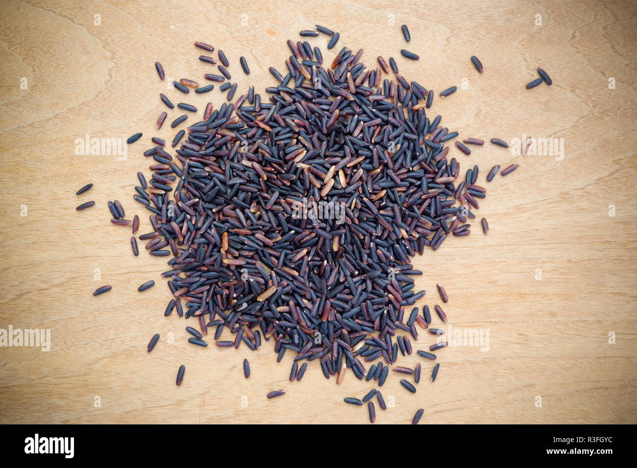 Riceberry organic food / pile of raw riceberries on wood background product agriculture of thail (Thai rice berry) Foto Stock