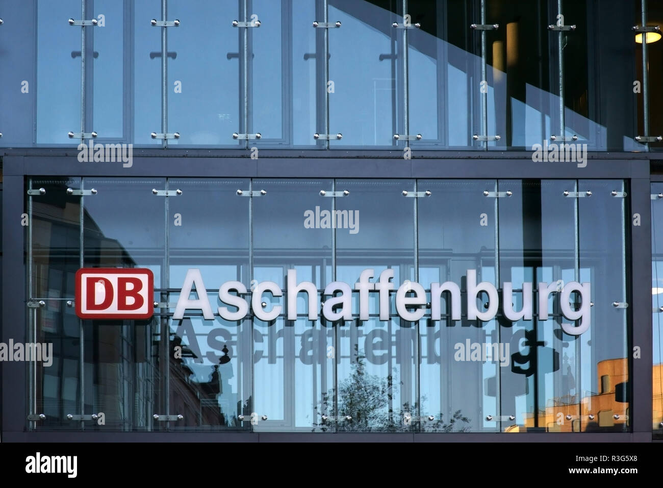 Aschaffenburg, Germania - 17 Novembre 2018: la moderna facciata in vetro come un elemento di design con il logo della Deutsche Bahn di Aschaffenburg central st Foto Stock