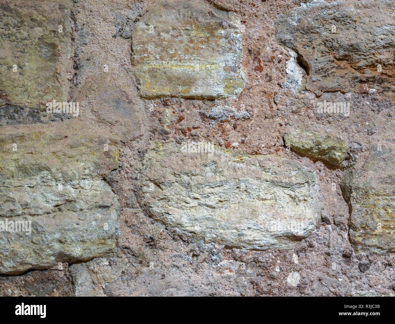 Tessitura della pietra, la superficie di parete di un vecchio edificio. Foto Stock