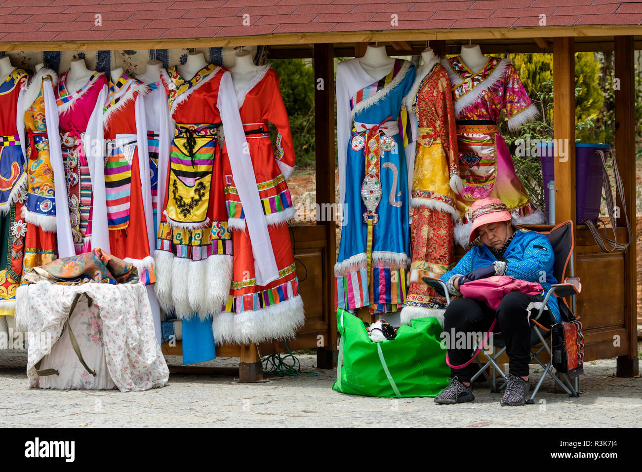 La Cina, nella provincia dello Yunnan, Northwestern Yunnan, Shangri-La, piazza della città. Colorati abiti tibetani che i turisti possono vestire per fotografie. Foto Stock