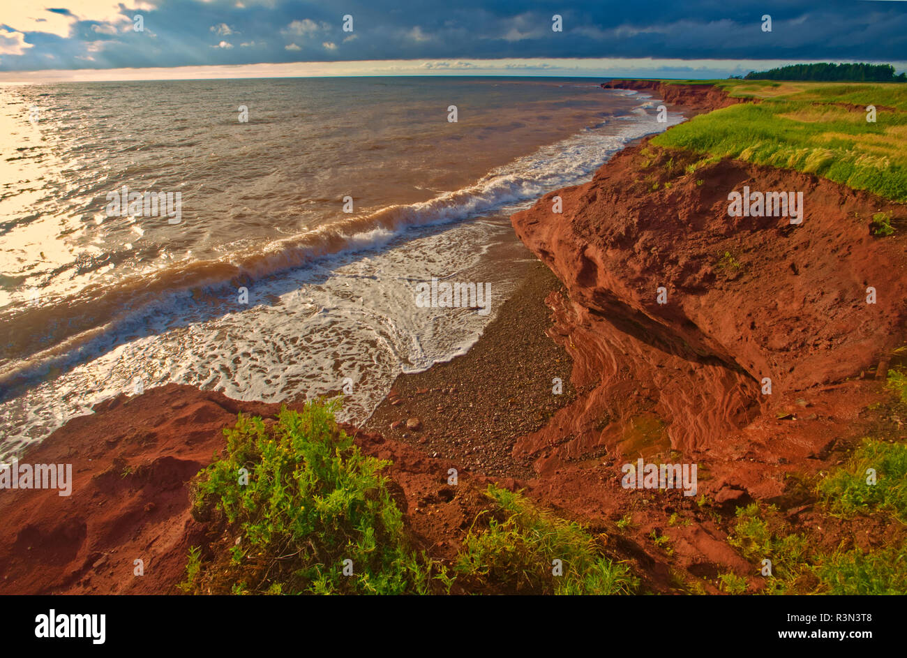 Canada, Prince Edward Island, Seacow Pond. Pietra arenaria rossa scogliere lungo l'oceano. Foto Stock