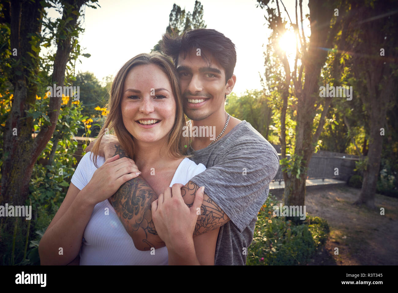 Felice coppia giovane flirtare in un parco in estate Foto Stock