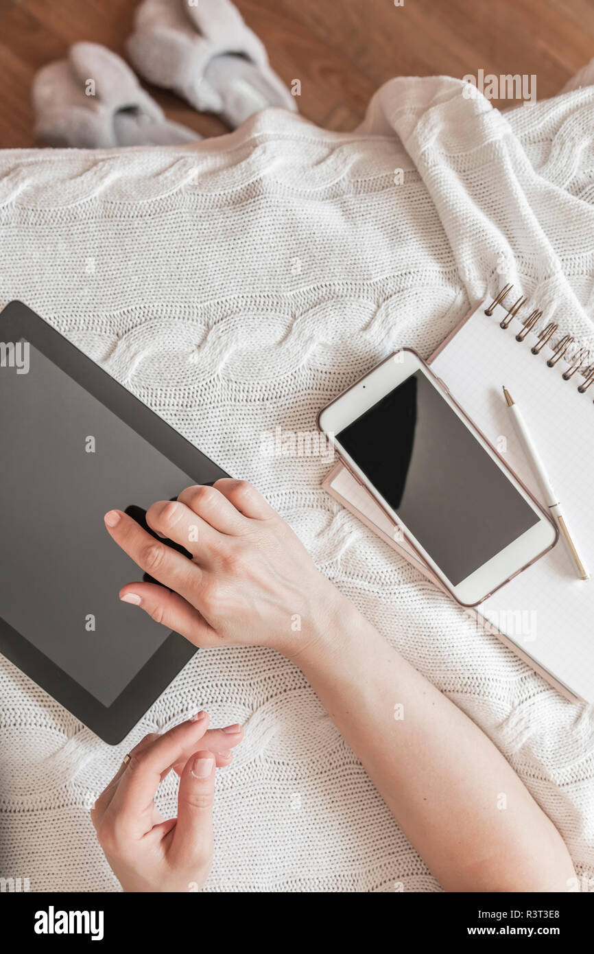 Donna di mano con tavoletta digitale a casa, vista dall'alto Foto Stock