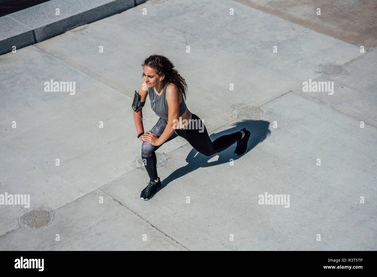 Atletica Giovane donna stretching all'aperto Foto Stock