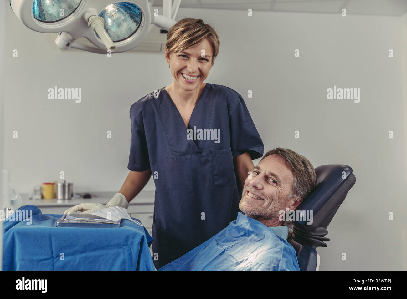 Chirurgo dentista parlando al paziente prima del trattamento Foto Stock