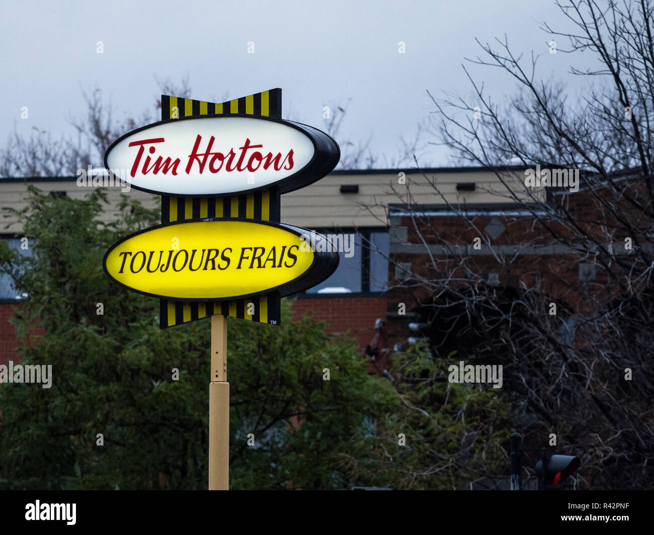 MONTREAL, Canada - 3 Novembre 2018: Tim Hortons logo nella parte anteriore di uno dei loro ristoranti in Québec con la loro sogan in francese. Tim Hortons è un cafe Foto Stock