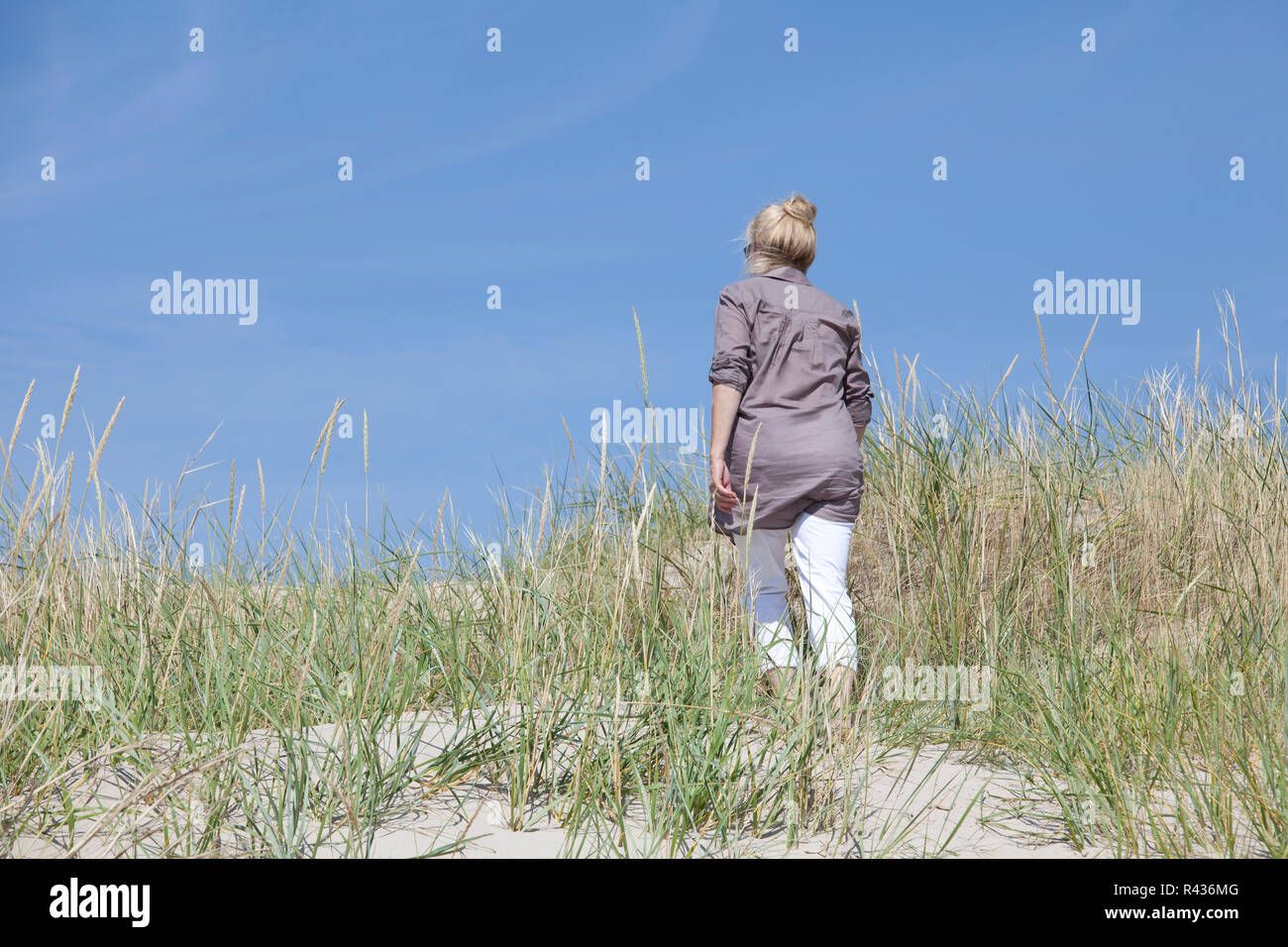 I turisti a piedi attraverso le dune Foto Stock