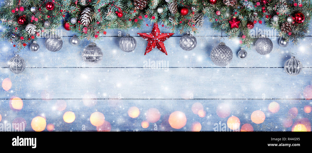 Baubles di Natale con Stella In Abete rami su terreni innevati tavolato in legno Foto Stock