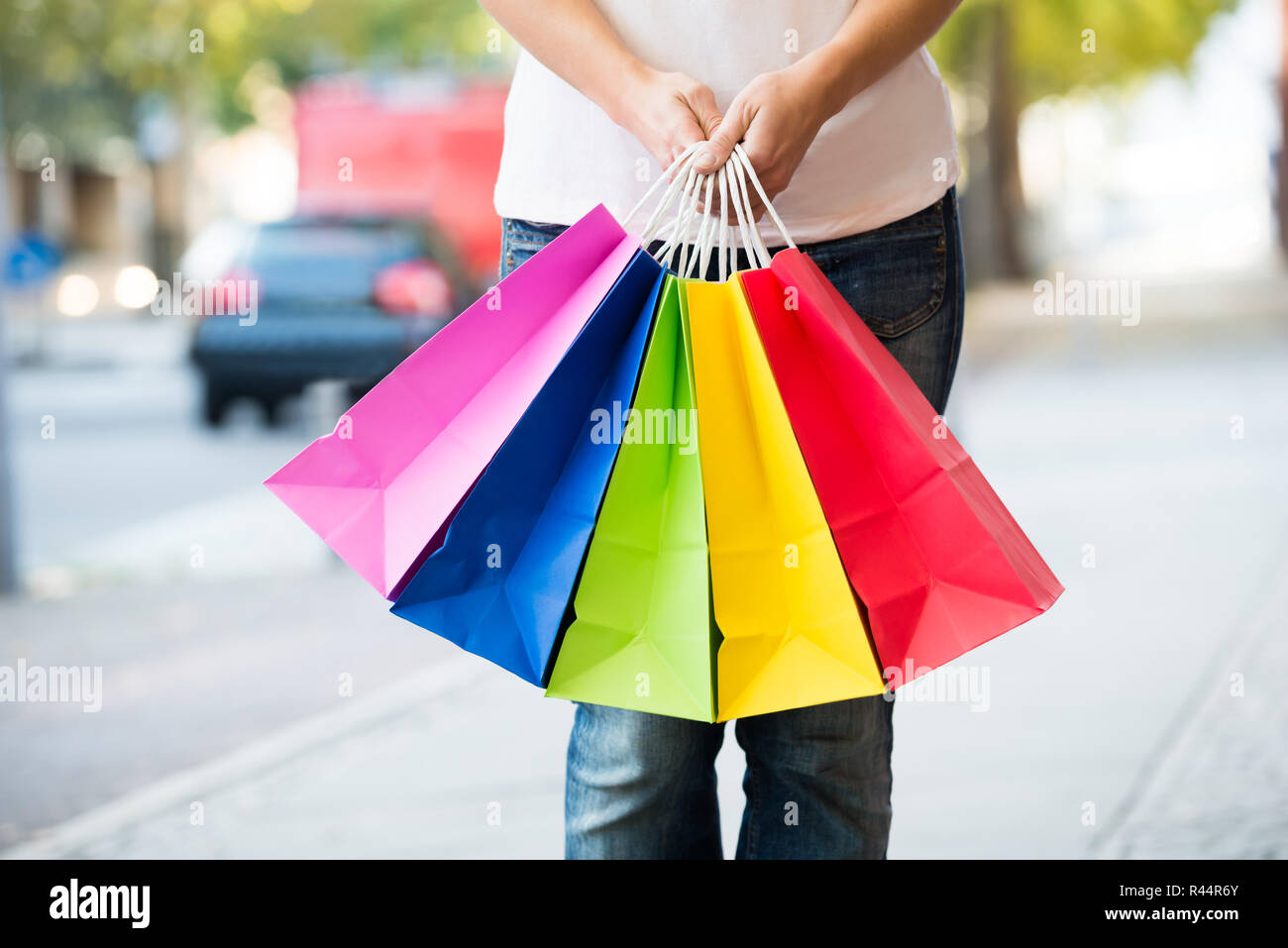Sezione mediana della donna azienda colorato borse per lo shopping Foto Stock