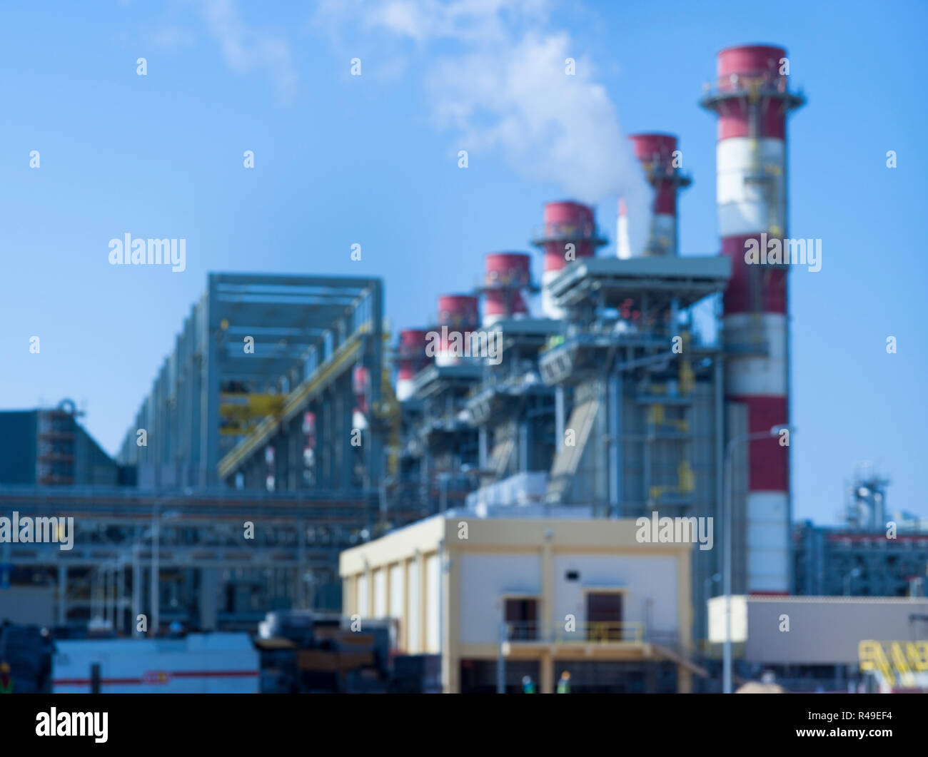 Industriali sfocata l'immagine di sfondo di un impianto di alimentazione esterno su una giornata di sole Foto Stock
