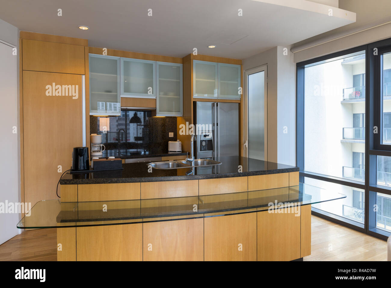 Lussuoso di legno pulito e Moderna Cucina con bancone di vetro Aga Foto Stock