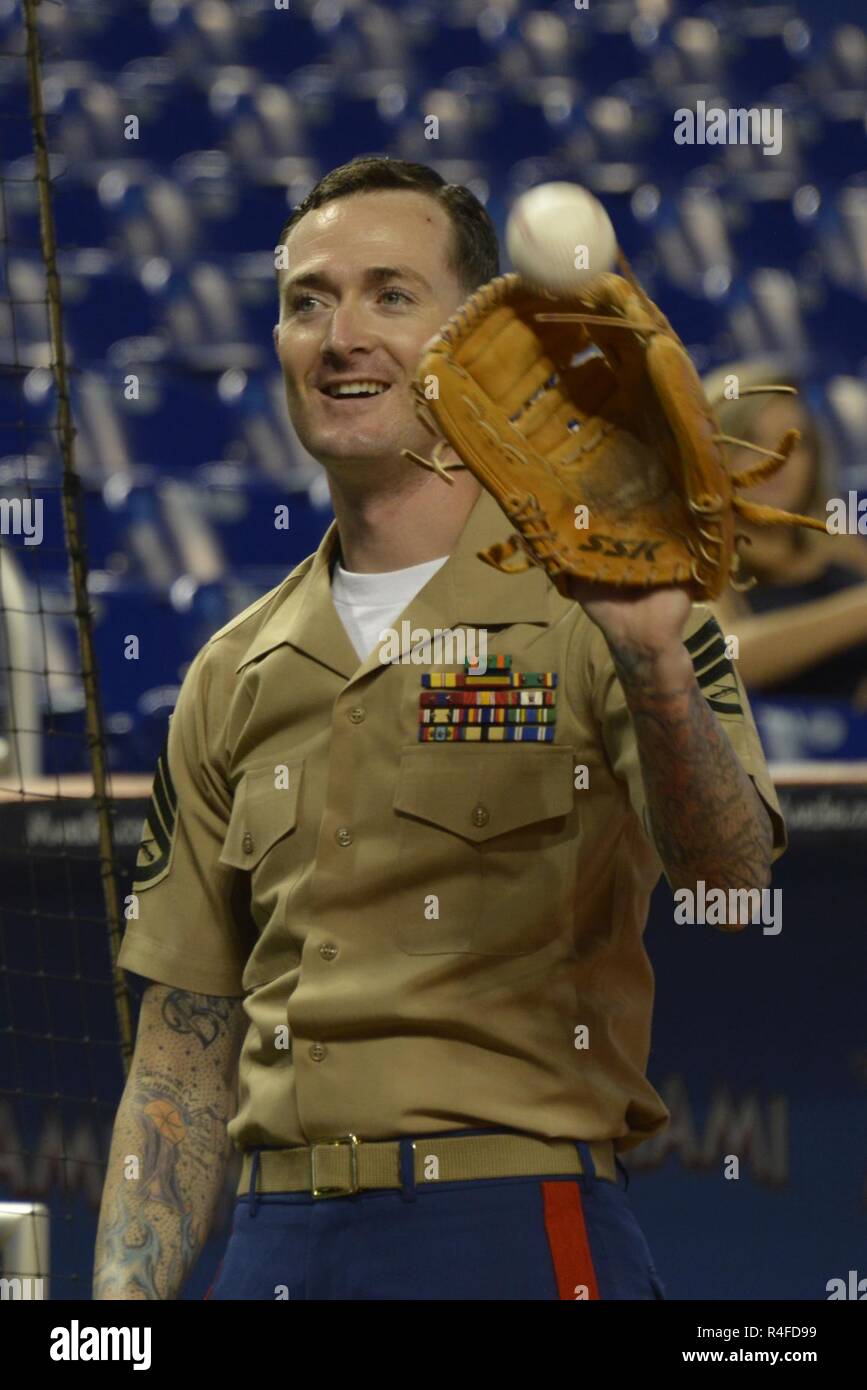 MIAMI, FLORIDA -- Staff Sgt. Jeremy R. Plympton aiuta l'ammiraglio posteriore Roy I. Kitchener scaldarsi prima ai Marlins raggi rispetto alla partita di baseball al Marlins Stadium 2 maggio 2017. Kitchener, il comandante di Expeditionary Strike gruppo 2, gettò il gioco apertura sfera come parte della ventisettesima edizione della Settimana della flotta Port Everglades. Plympton, uno di più di 100 II Marine forza expeditionary Marines che partecipano nella settimana della flotta è il plotone armi sergente per India Company, 3° Battaglione, 2° Reggimento Marine. Foto Stock