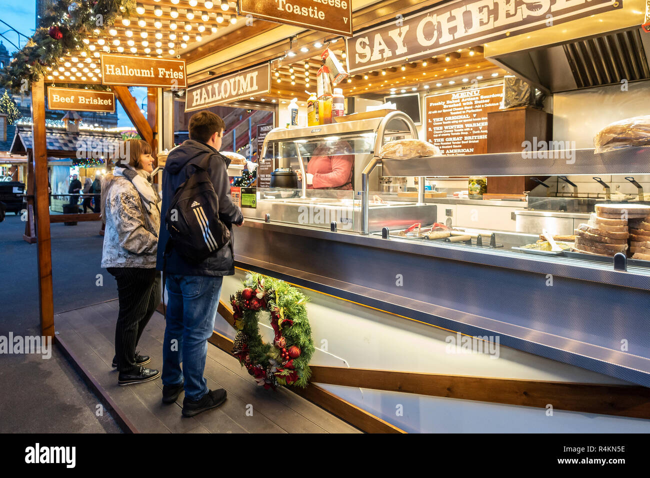 I clienti ad un piede di strada bancarella vendendo a caldo a base di formaggio, tariffa compresi Halloumi patatine fritte e formaggio Toasties e punta di petto di manzo. George Square, Glasgow Foto Stock