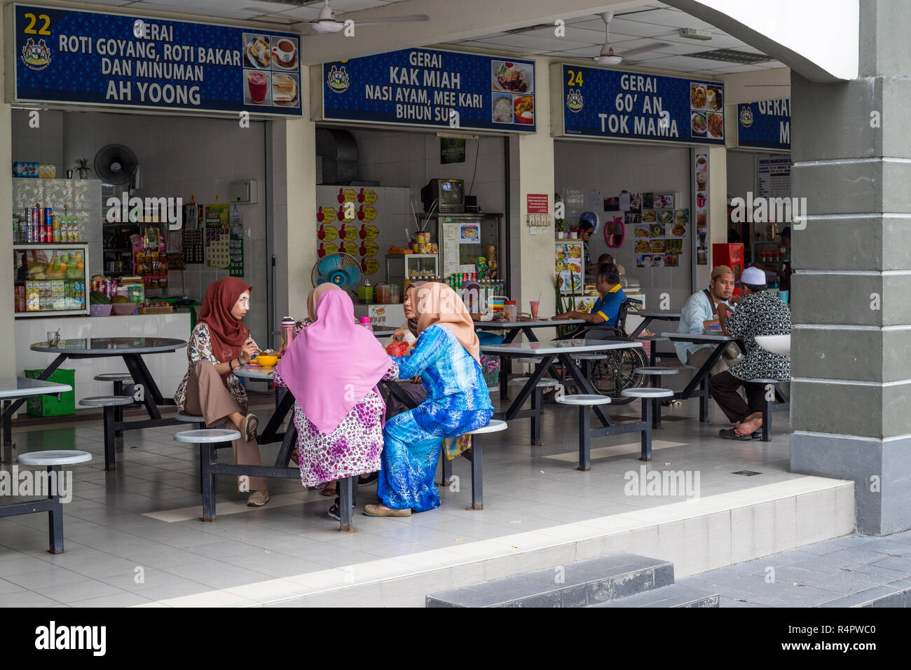Malaysian donne aventi il pranzo presso i fornitori di prodotti alimentari Shared area salotto, Ipoh, Malaysia. Foto Stock