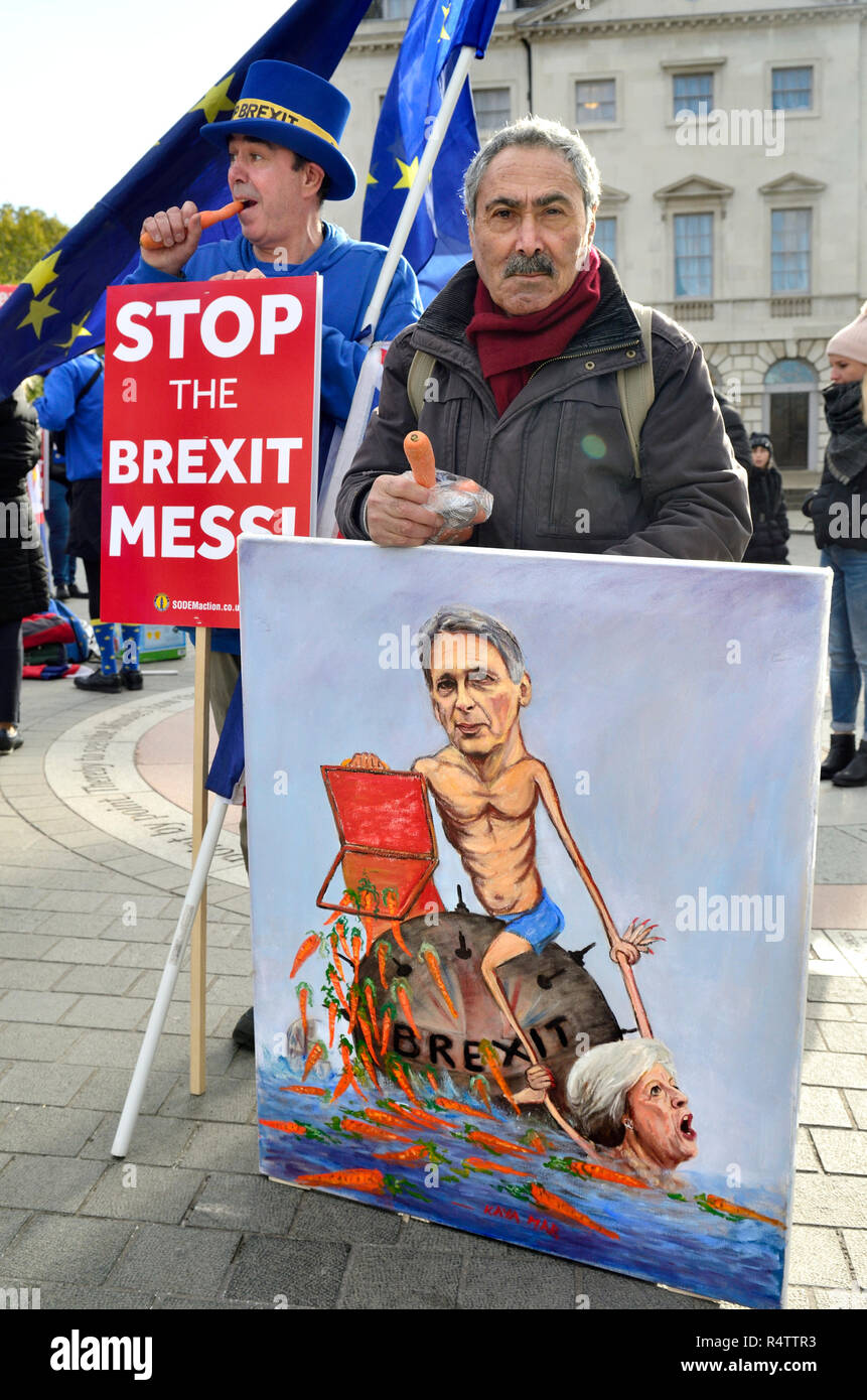 Kaya Mar - Fumettista politico - con uno dei suoi dipinti Brexit Philip Hammond con un bilancio scatola piena di carote e Theresa Maggio, affondando. Steve Br Foto Stock