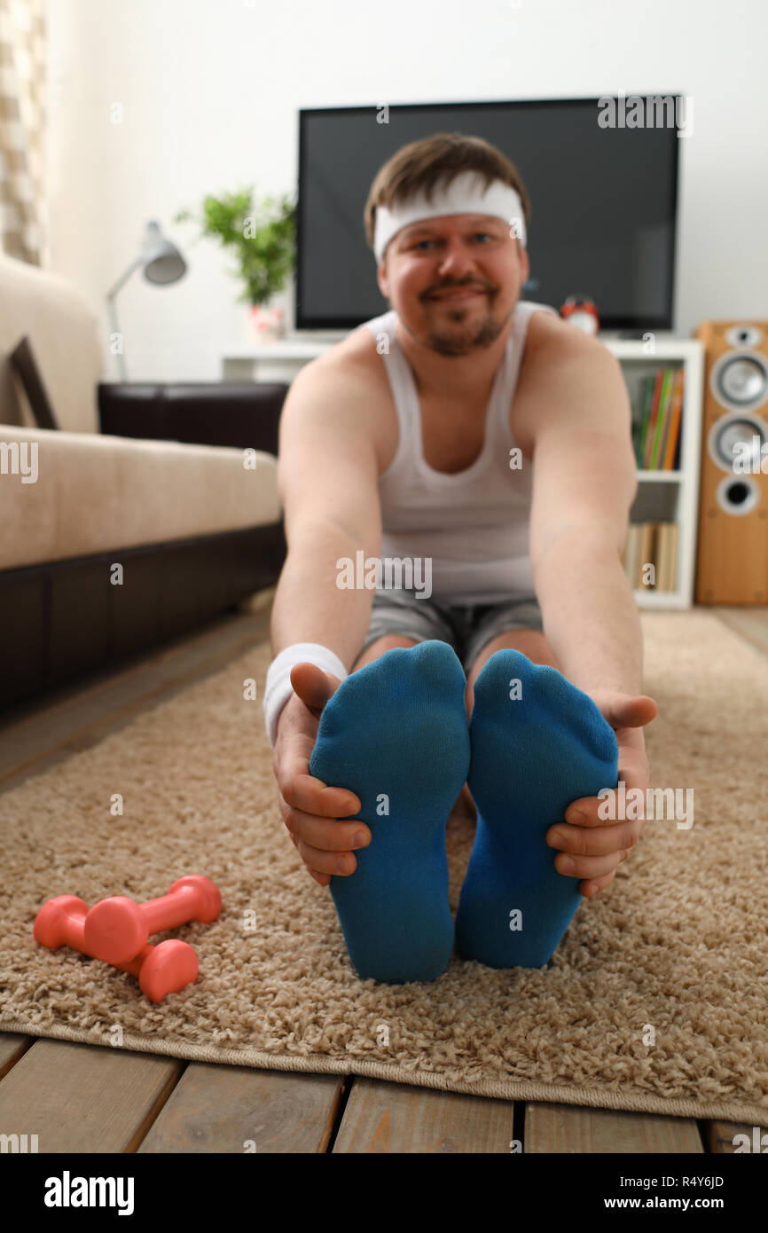 Giovani attraenti uomo fitness giace su un tappeto di grasso con Foto Stock