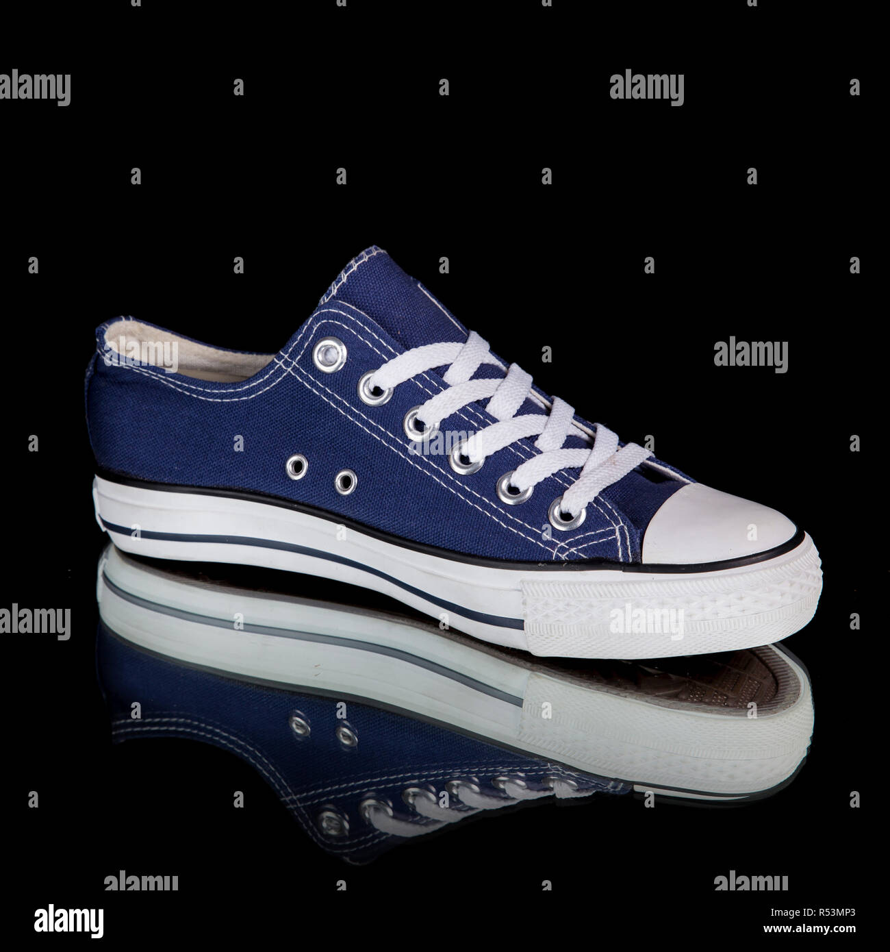 Sneaker maschio blu e bianco su sfondo nero, prodotto isolato. Foto Stock