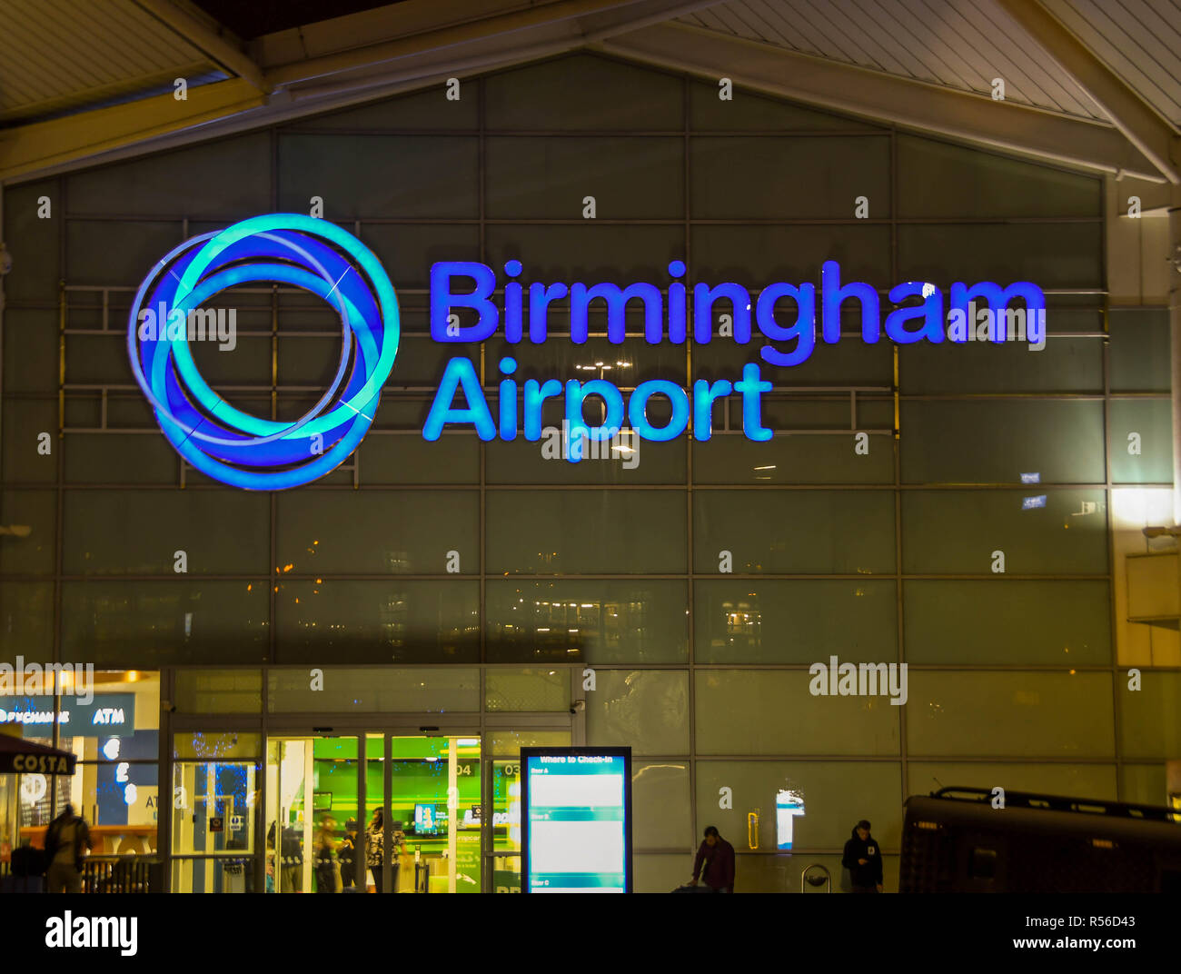 Segnale illuminato sulla parte anteriore dell'edificio del terminal dell aeroporto di Birmingham di notte Foto Stock