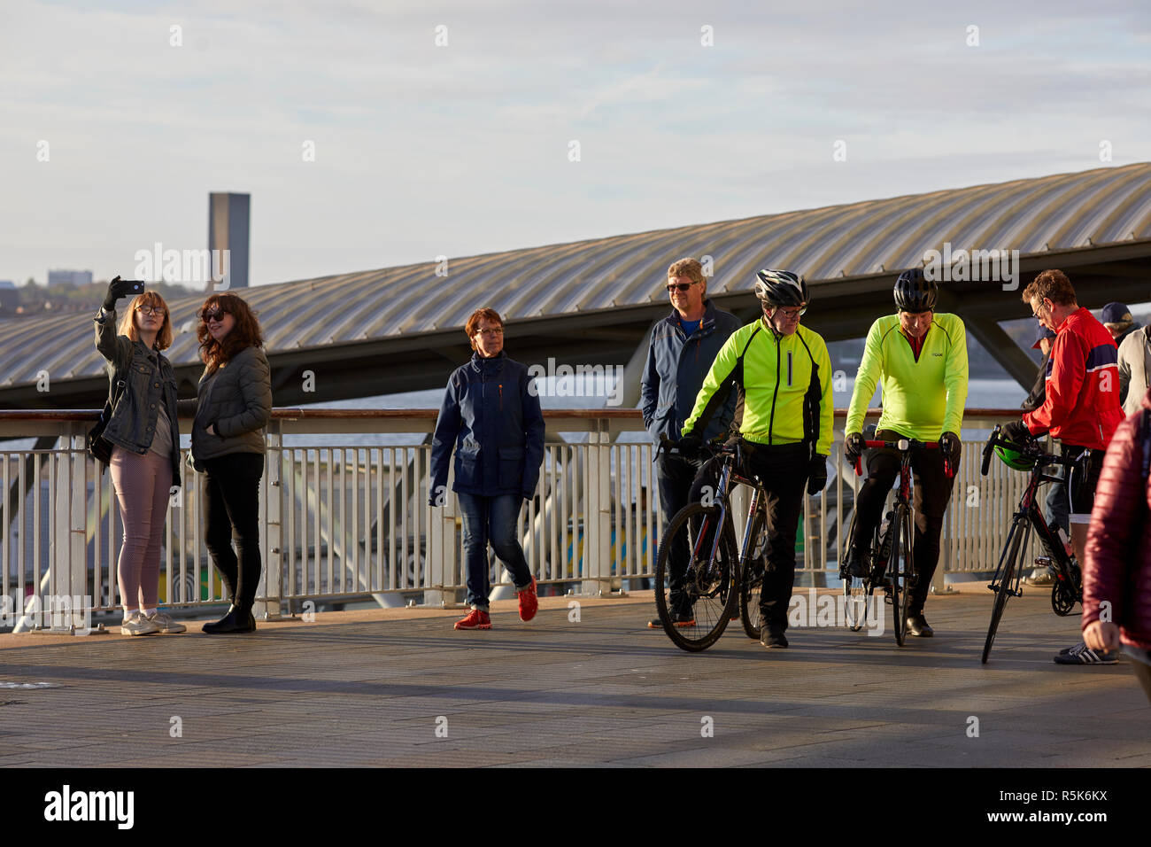 Pier Head Liverpool Waterfront turistico e i ciclisti resto sul molo Foto Stock