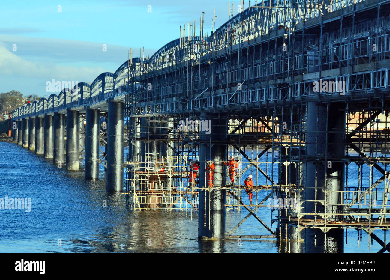 Operai effettuare le riparazioni al di sotto del ponte ferroviario che attraversano il bacino di Montrose in Angus, Scozia. Foto Stock