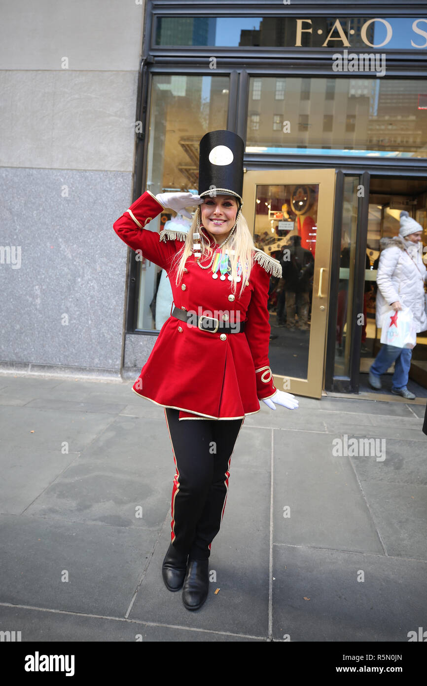 Un portiere vestito come un soldato giocattolo si erge al di fuori recentemente riaperto la FAO Schwarz flagship store al Rockefeller Plaza nel centro di Manhattan Foto Stock