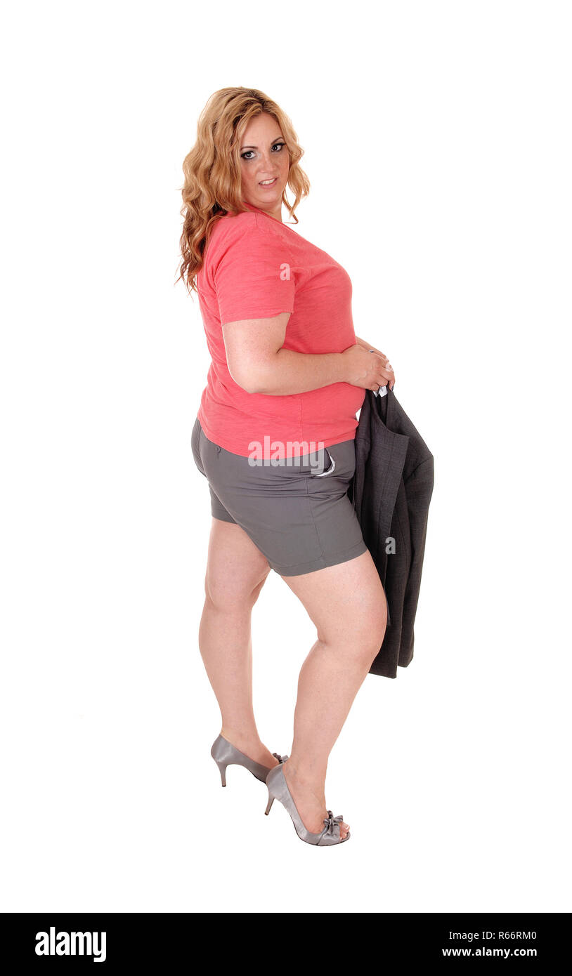 Donna in pantaloncini corti e tacchi in piedi Foto Stock