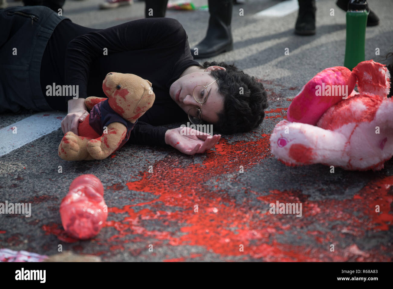 (181204) -- Gerusalemme il 4 dicembre, 2018 (Xinhua) -- un manifestante si trova su una strada verniciato con vernice rossa durante una manifestazione di protesta contro la violenza verso le donne a David Arpa Bridge in Gerusalemme, il 4 dicembre 2018. Le donne in Israele ha lanciato martedì un sciopero nazionale per protestare contro la violenza verso le donne. Lo sciopero è stato innescato dalla uccisione di due ragazze la scorsa settimana, portando il numero di morti di donne e ragazze in Israele a 24 quest'anno. (Xinhua/JINI) Foto Stock